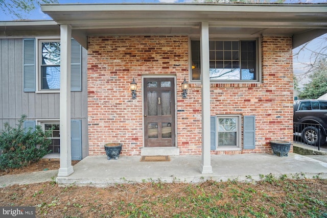 view of exterior entry featuring a porch