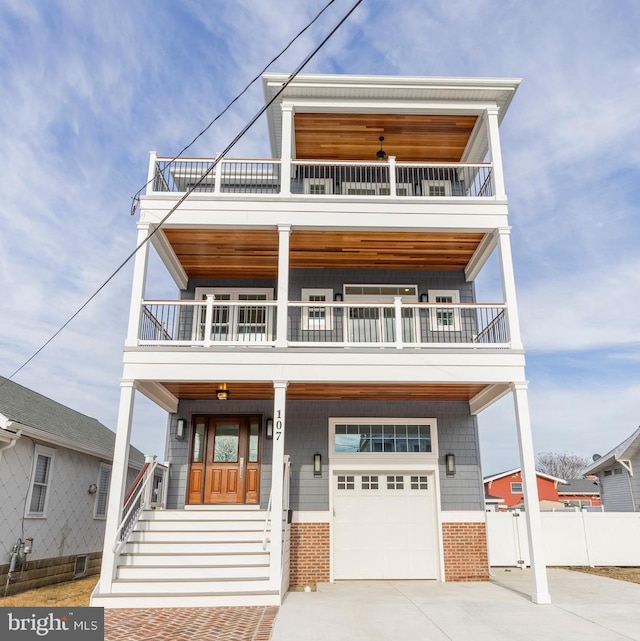 view of front of home featuring a garage, a balcony, and covered porch