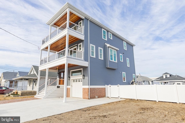 view of front of property with a garage and a balcony