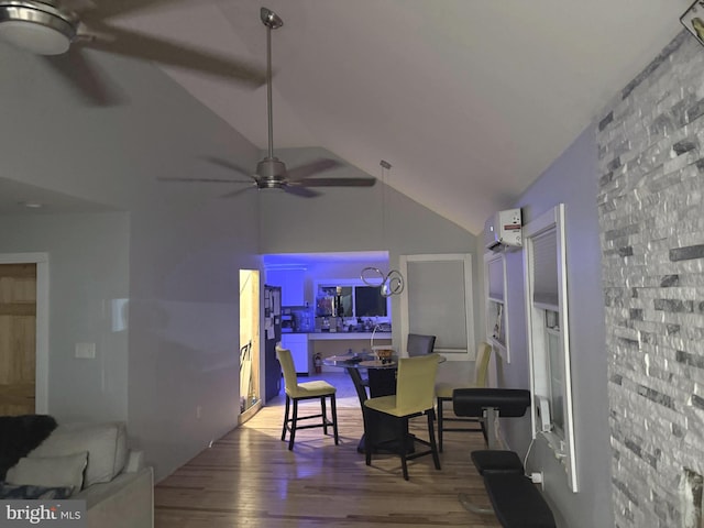 living room with hardwood / wood-style flooring, ceiling fan, a wall mounted AC, and high vaulted ceiling