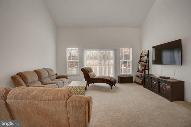 living room featuring vaulted ceiling and carpet floors