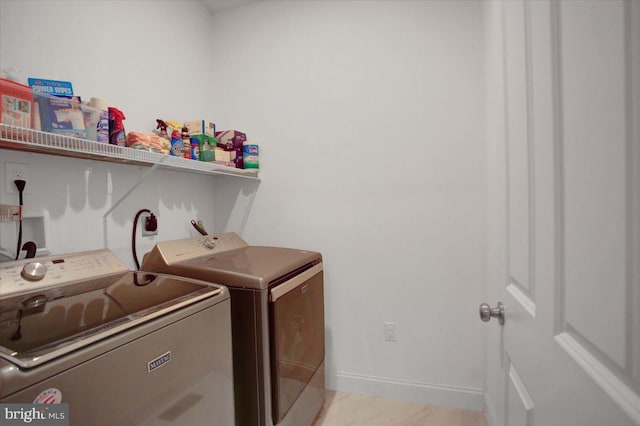 laundry room featuring laundry area, independent washer and dryer, and baseboards