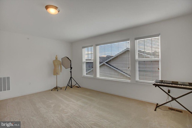 spare room featuring carpet and visible vents