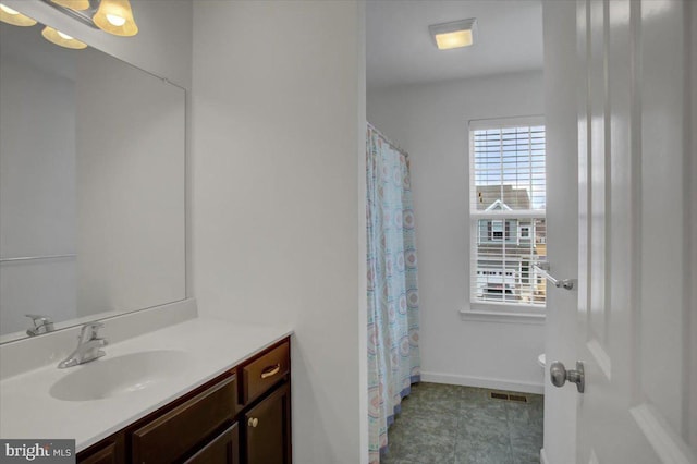 full bathroom featuring baseboards, visible vents, and vanity