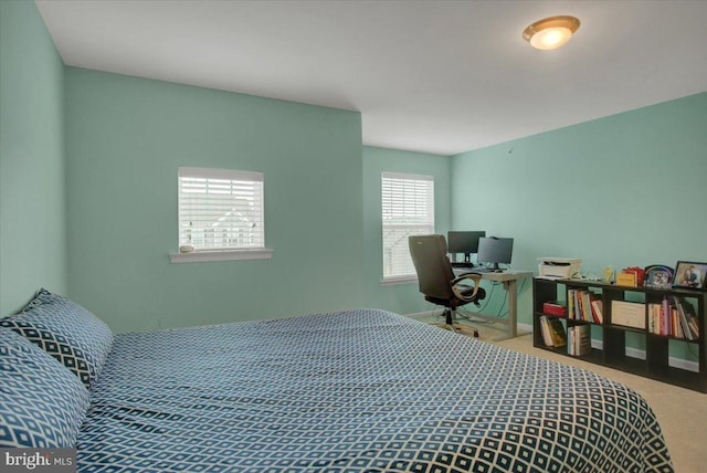 bedroom with carpet and baseboards