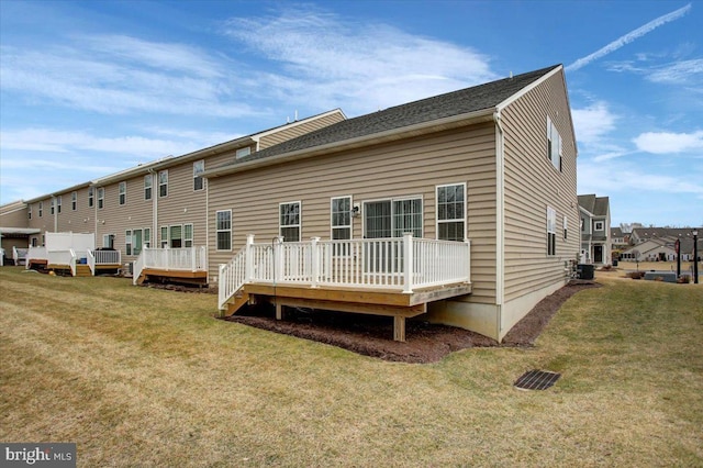 back of property featuring central AC unit, a lawn, and a wooden deck