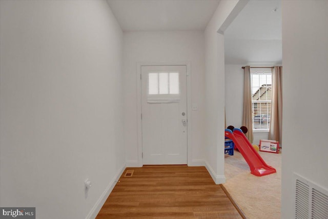 interior space with visible vents, baseboards, and wood finished floors