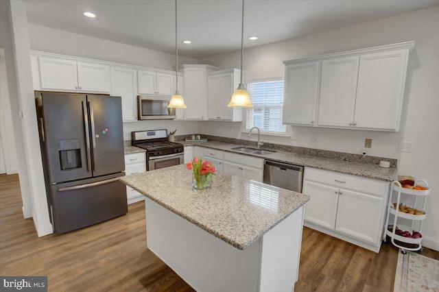 kitchen featuring white cabinetry, appliances with stainless steel finishes, dark wood-type flooring, and a sink