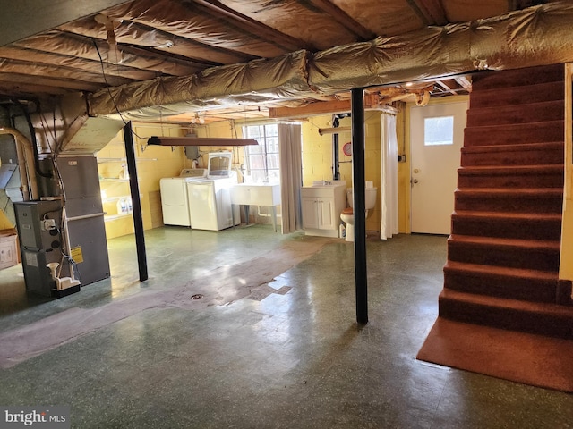 basement with separate washer and dryer and heating unit