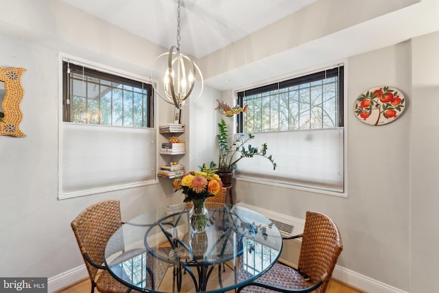 dining area featuring a healthy amount of sunlight and a notable chandelier