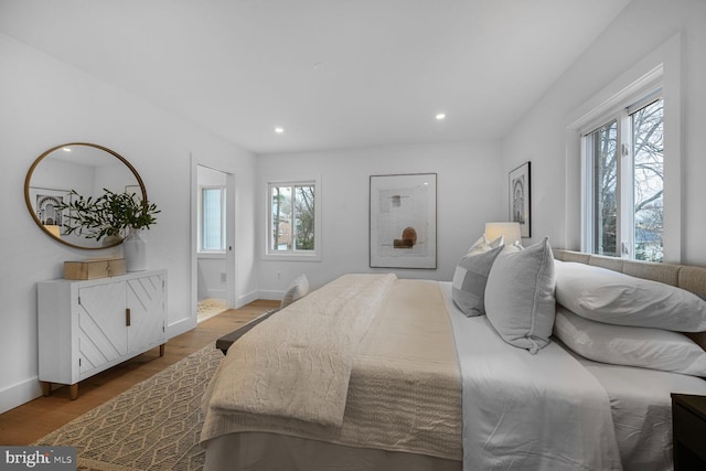 bedroom with recessed lighting, light wood-style flooring, and baseboards