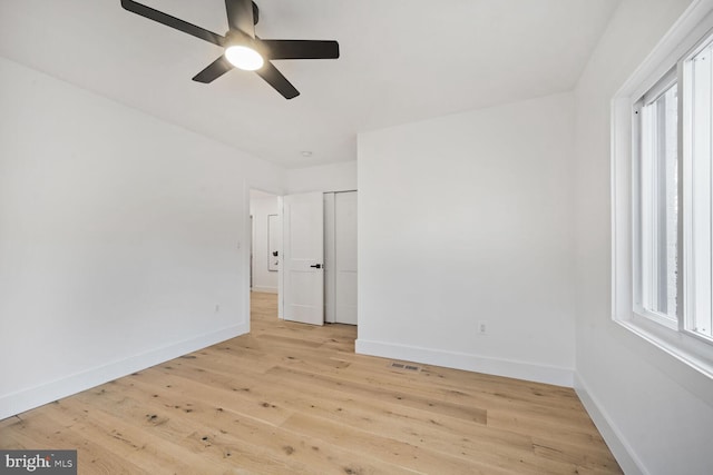 unfurnished bedroom with light wood finished floors, visible vents, baseboards, and ceiling fan