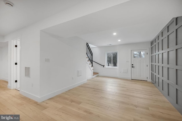 entrance foyer with recessed lighting, visible vents, stairway, light wood-type flooring, and baseboards