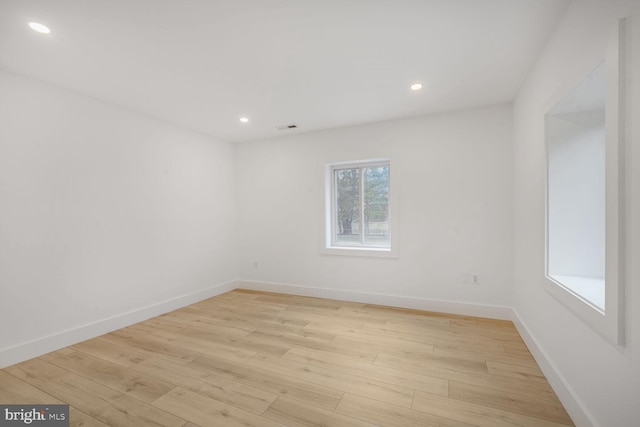 unfurnished room with recessed lighting, light wood-style flooring, and baseboards