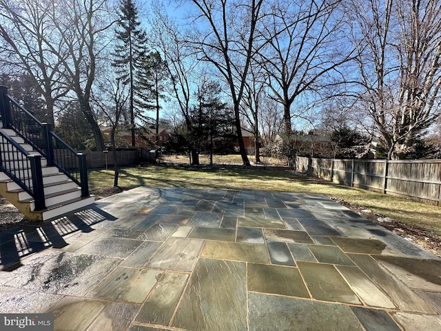 view of patio featuring a fenced backyard and stairway