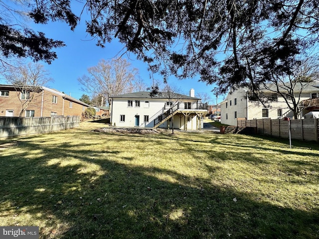 rear view of house with stairs, a lawn, fence, and a residential view