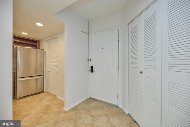 hall with light tile patterned flooring