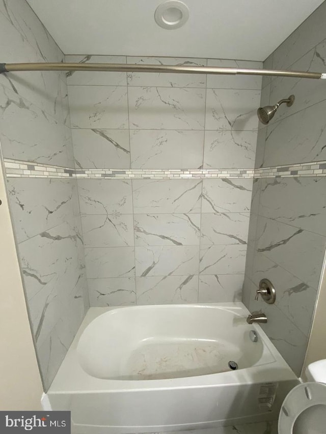 full bathroom with shower / bath combination and toilet