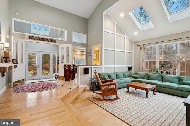 interior space with lofted ceiling with skylight, a wealth of natural light, and french doors