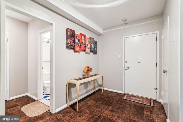 foyer with dark parquet floors