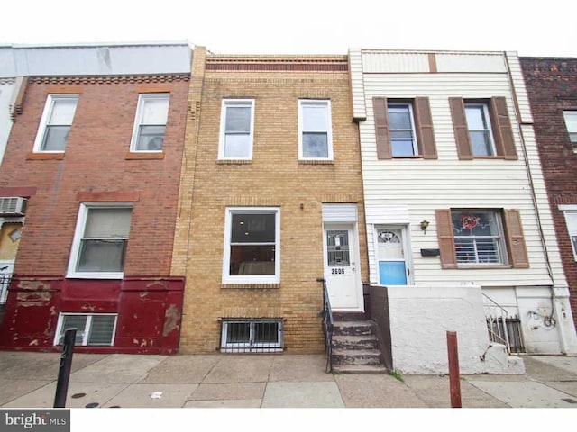 multi unit property with an AC wall unit and brick siding