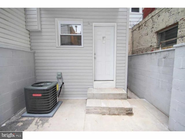 entrance to property with fence and central AC unit