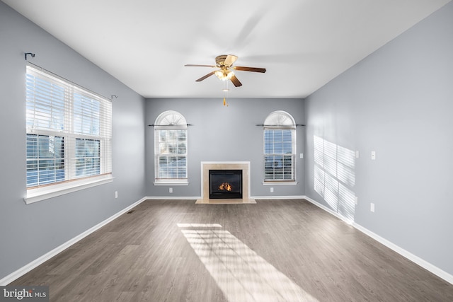 unfurnished living room featuring wood-type flooring and ceiling fan