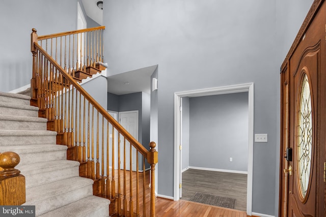 foyer with a high ceiling and light wood-type flooring