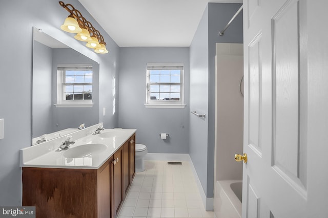 full bathroom with vanity, tile patterned flooring, a wealth of natural light, and toilet