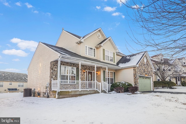 view of front of house featuring central AC, a porch, and a garage