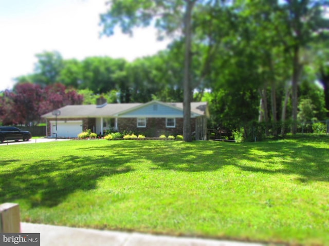 view of front of home with a front yard and an attached garage