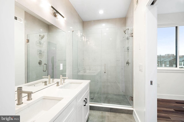 bathroom featuring vanity, an enclosed shower, and hardwood / wood-style floors