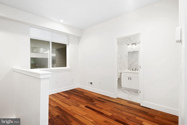 empty room with recessed lighting, visible vents, baseboards, and wood finished floors