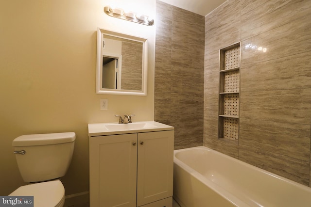 bathroom featuring a washtub, vanity, and toilet