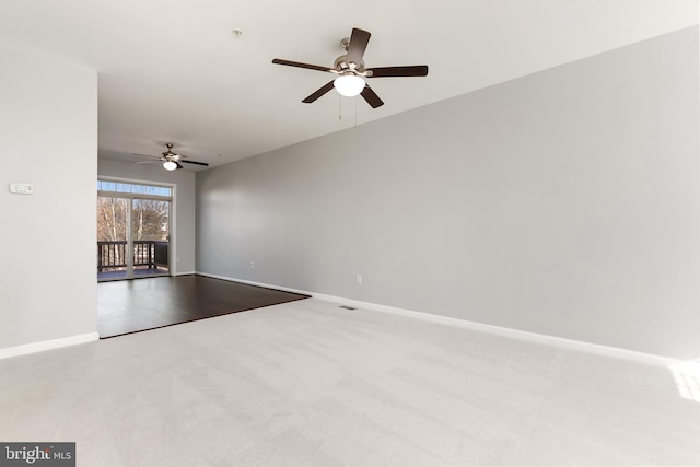 spare room with baseboards and light colored carpet