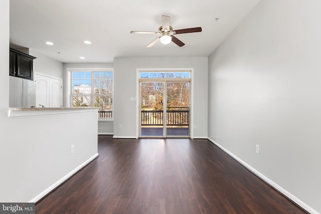 unfurnished living room featuring ceiling fan, baseboards, dark wood-type flooring, and recessed lighting