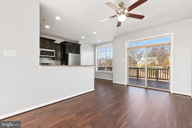 unfurnished living room with dark wood-style flooring, recessed lighting, a ceiling fan, and baseboards