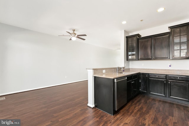 kitchen featuring dark wood-style flooring, stainless steel dishwasher, glass insert cabinets, a peninsula, and baseboards