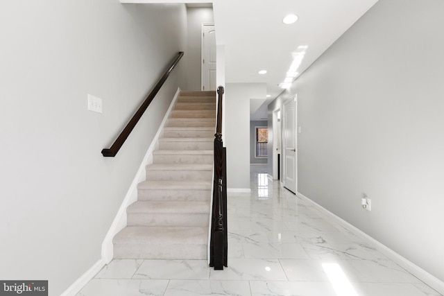 stairs with marble finish floor, recessed lighting, and baseboards