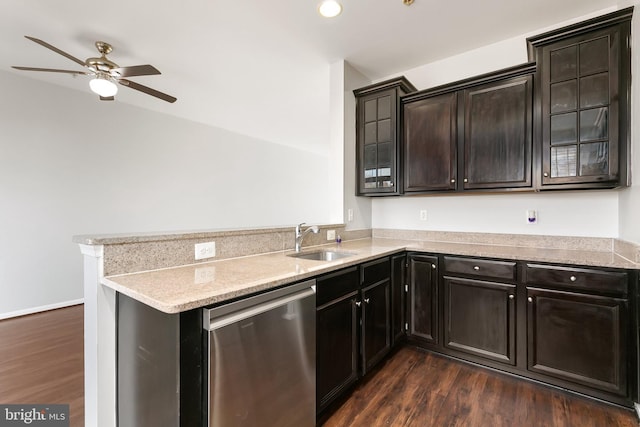 kitchen with dark wood-style floors, glass insert cabinets, a peninsula, stainless steel dishwasher, and a sink