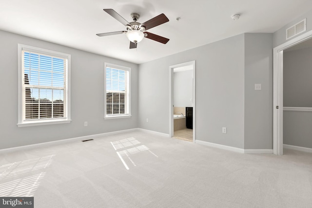 unfurnished bedroom with light carpet, baseboards, and visible vents