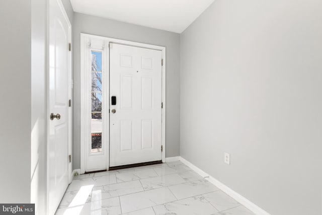 entryway featuring marble finish floor and baseboards