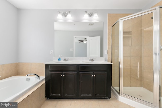 bathroom with a bath, a stall shower, visible vents, and a sink