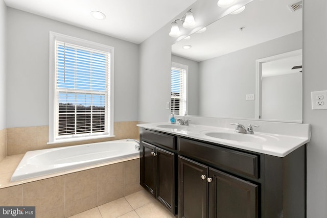 full bath featuring double vanity, a sink, visible vents, and tile patterned floors