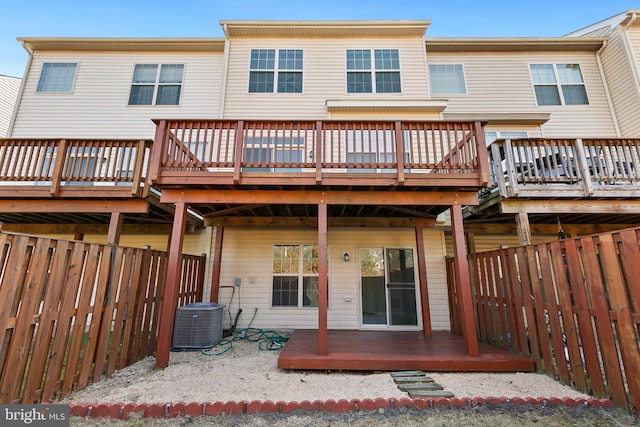 back of house with central AC, a fenced backyard, and a deck