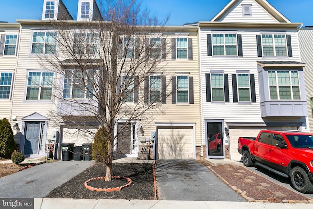 view of property with a garage and driveway