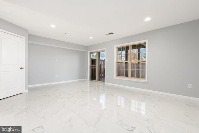 spare room with marble finish floor, visible vents, baseboards, and recessed lighting