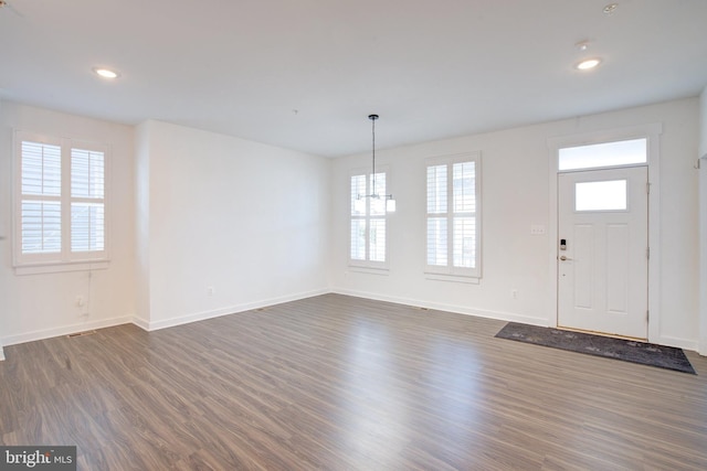 foyer featuring dark wood-type flooring, recessed lighting, and baseboards