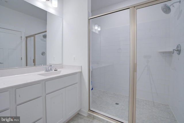 full bathroom featuring a stall shower and vanity