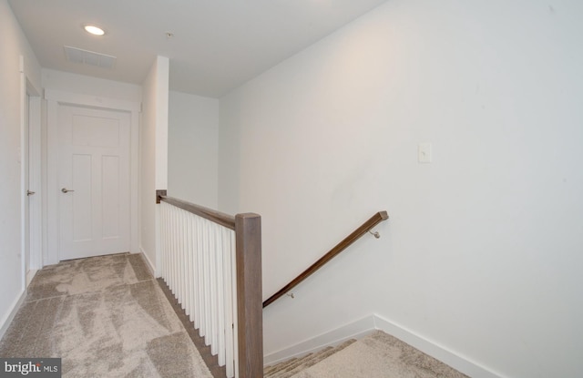 stairway with carpet flooring, visible vents, and baseboards